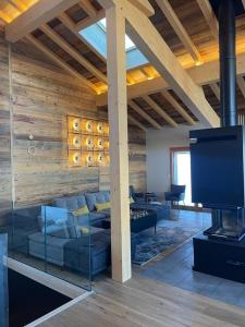 a living room with a couch and a flat screen tv at Somptueux chalet in Megève