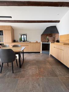 a kitchen with a table and chairs and a stove at La Magnanerie Maison Provençale in Gordes