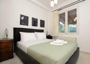 a bedroom with a bed with two towels on it at Casa Di Aspa in Rethymno Town +20 photos