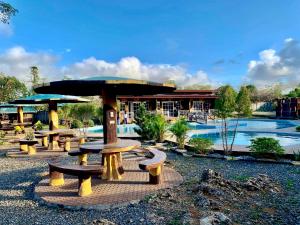 a group of picnic tables in front of a resort at F1 Green Meadows Resort in Arnedo