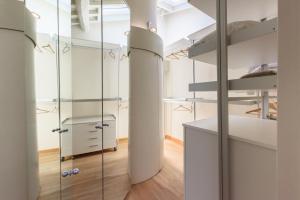 a room with glass dividers and a bedroom with a bed at GOLDEN LUXE - Botero Loft Design Penthouse in Pietrasanta
