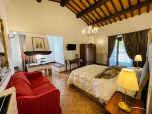 a bedroom with a bed and a chair and a table at Agriturismo Eco-Bio Villa Vacasio in Pitigliano