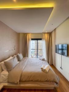 a bedroom with a large bed and a window at Pearl Chic Stay Pool and View in Rabat