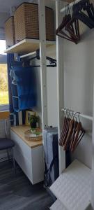 a room with a closet with shelves and shoes at Rosehill Beach in Hemsby