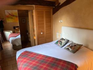 a bedroom with a bed with two pillows on it at LE CLOS PASTEL Chambres d'hôtes et son studio suite - ADULTES ONLY in Virac +90 photos