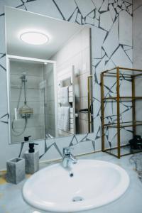 a bathroom with a sink and a mirror at Sewwa Guest House in Sélestat