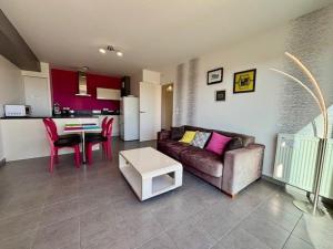 a living room with a couch and a table at Quiberon : Appartement 2P avec Terrasse et Animaux Acceptés - FR-1-478-32 in Quiberon