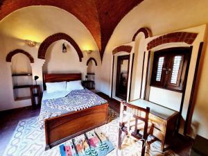 a bedroom with a bed in a room with arches at Villa Rosamund in Luxor