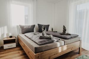 a bedroom with a bed with two pillows on it at Bergluft Suiten Edelsberg und Falkenstein in Pfronten