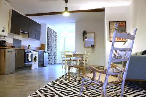 a kitchen and living room with a table and chairs at Plain pied cosy à 20 minutes de bordeaux - Le Clos Montichamp in Camblanes-et-Meynac