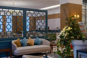 a living room with a couch with pillows on it at Hotel London 1889 & Casino in Batumi +77 photos