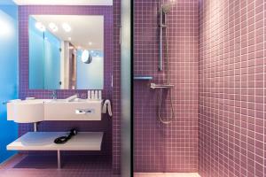 a pink bathroom with a sink and a shower at Radisson Blu Resort & Spa in Split