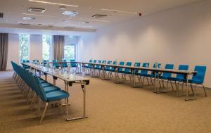 a conference room with long tables and blue chairs at Radisson Blu Resort & Spa in Split
