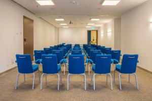 an empty room with blue chairs in it at Radisson Blu Resort & Spa in Split