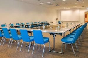 a large conference room with a long table and blue chairs at Radisson Blu Resort & Spa in Split