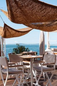 a patio with a table and chairs and the ocean at Radisson Blu Resort & Spa in Split