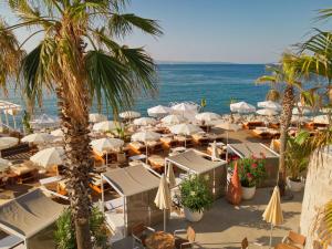 a beach with chairs and umbrellas and the ocean at Radisson Blu Resort & Spa in Split