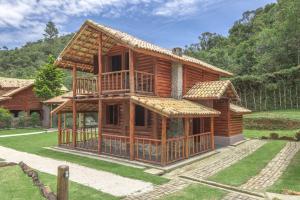 a wooden house under construction in a yard at Pousada Cachoeira da Barra in Cunha