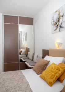 una camera da letto con due letti e uno specchio di Room Beta with sea view a Dubrovnik