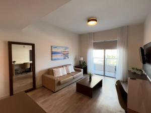 a living room with a couch and a table at A Fantastic apart with balcony and partial view of the beach 4 Px in Hollywood