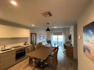 a kitchen and living room with a table and chairs at A Fantastic apart with balcony and partial view of the beach 4 Px in Hollywood