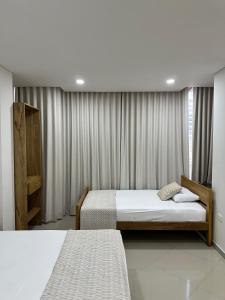 Postel nebo postele na pokoji v ubytování Hotel El Faro - Desayunos incluidos - Manga, Cartagena