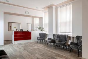 a waiting room with chairs and a red desk at Koruna Hotel in Prague