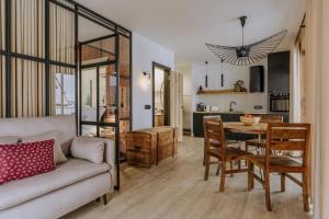 a living room and kitchen with a couch and a table at Tatra Panorama Residence - Ski, Hike & Relax Retreat in Zakopane +41 photos
