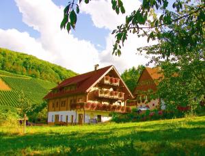 a large house with flowers on the front of it at Weingut und Ferienhof Josef Huber in Oberkirch