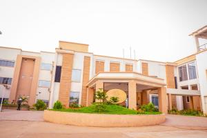 a building with a courtyard in front of it at Porto Golf Hotels in Kano +21 photos