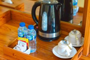 a drawer with two bottles of water and a kettle at Maja House Penida in Nusa Penida