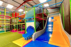 a play room with a slide and a slide at Camping maeva Escapades Country Park - Touquin in Touquin