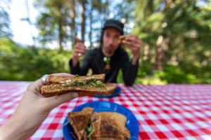 a man sitting at a table with a plate of food at Camping maeva Escapades Country Park - Touquin in Touquin +18 photos