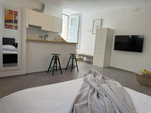 a living room with a kitchen and a counter top at Studio Rimac in Dubrovnik