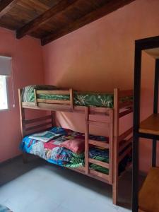 a bedroom with two bunk beds in a room at Cabaña al pie de las Sierras in Santa María