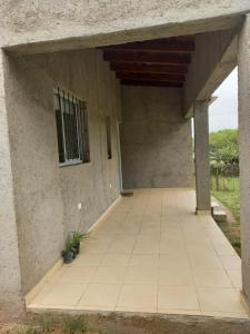 an empty patio of a house with a window at Cabaña al pie de las Sierras in Santa María +2 photos