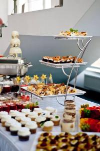 a buffet with many different types of desserts and pastries at Hotel George in Nadarzyn