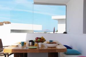 a wooden table with a bowl of fruit on it at Daidas Beach House - with hot whirlpool in Famara in Famara
