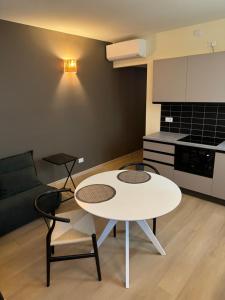 a living room with a white table and chairs at Apartment Menaggino in Menaggio
