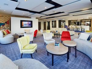 a lobby with couches and tables and chairs at Kyriad Troyes Centre in Troyes