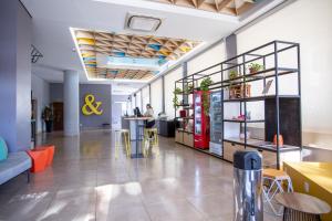 a lobby of an office with tables and chairs at B&B HOTEL Uberlândia in Uberlândia