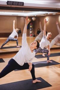 a group of people doing yoga in a gym at Sheraton Sopot Hotel in Sopot