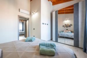a bedroom with a large mirror and a bed at Casa Matilde - Villa San Pietro in Villa San Pietro +26 photos
