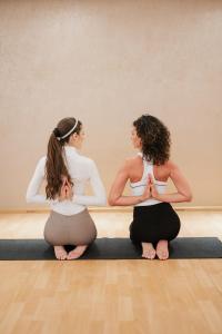 two pregnant women sitting in a yoga pose at Sheraton Sopot Hotel in Sopot