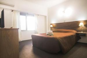 En eller flere senge i et værelse på Hotel Royal