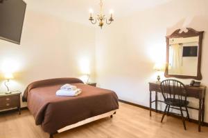 En eller flere senge i et værelse på Hotel Royal