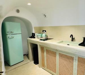 cocina con nevera verde y fregadero en SantorOia Luxury Suites by Caldera Houses, en Oia