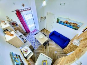 an overhead view of a living room with a blue couch at Seafront House Gabbiano Blu in Santa Flavia +41 photos