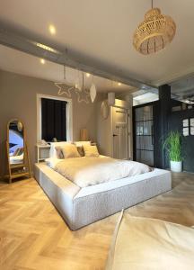 a bedroom with a large bed in a room at Sparkle privé wellness B&B in Franeker