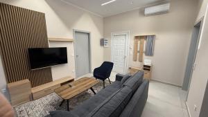 a living room with a couch and a tv at Elias house in Tríkala